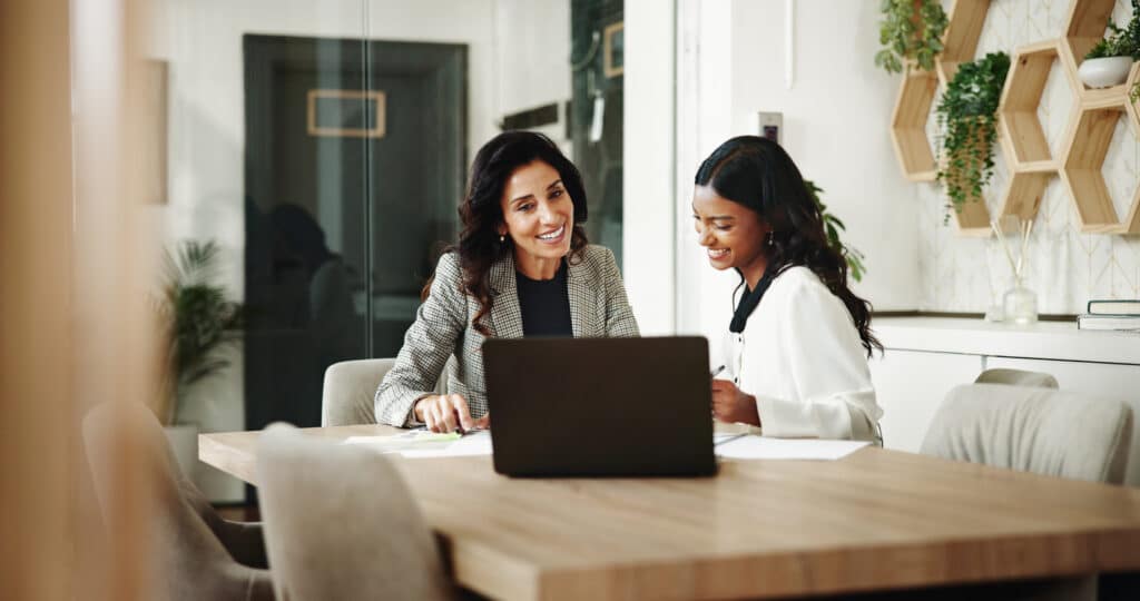 two woman discussing choosing an outsourced HR company
